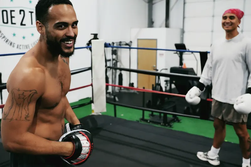 Jeremiah smiling with the mitts on, ringside